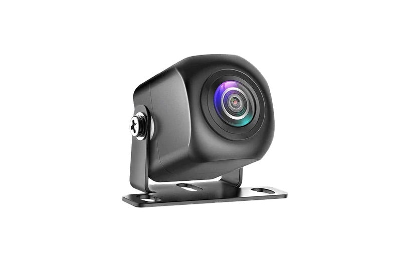 A black reversing camera, with purple and blue reflections on the lens, on a white background